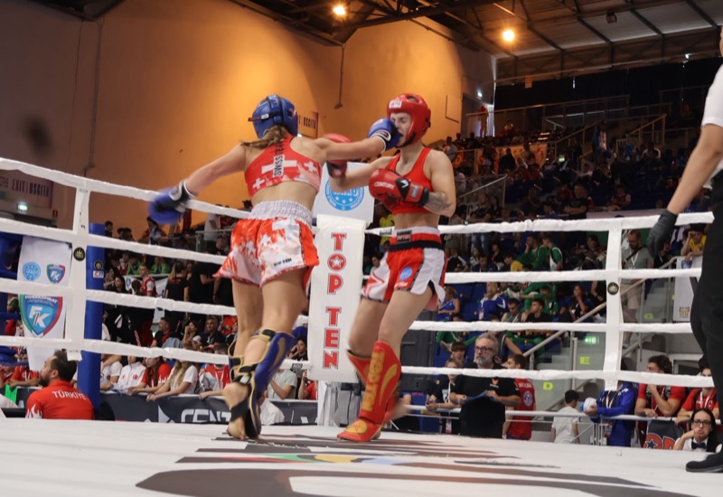 Eva Tschanz punching in the ring at a WAKO competition